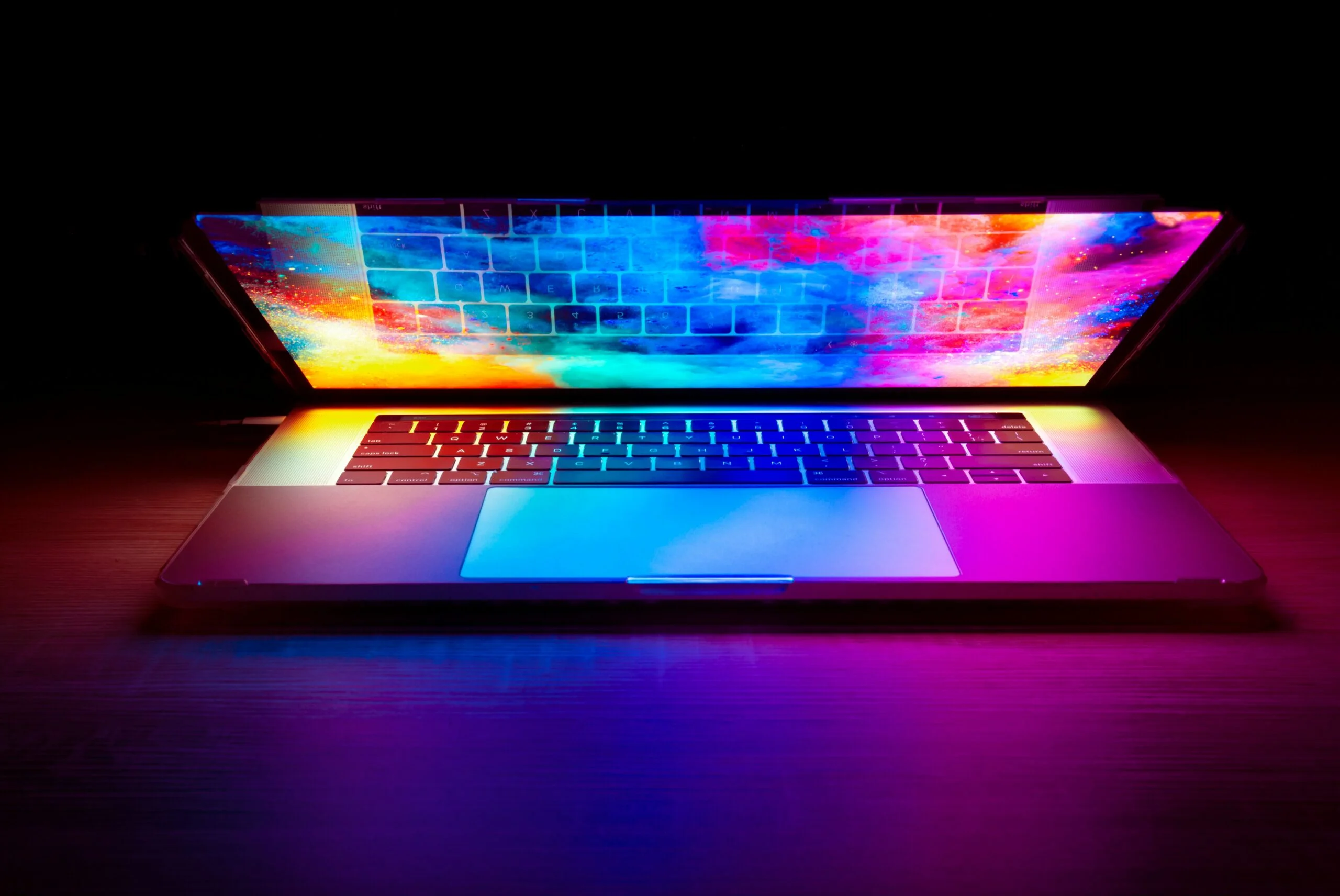 Laptop with a colorful and vibrant screen in a dark room