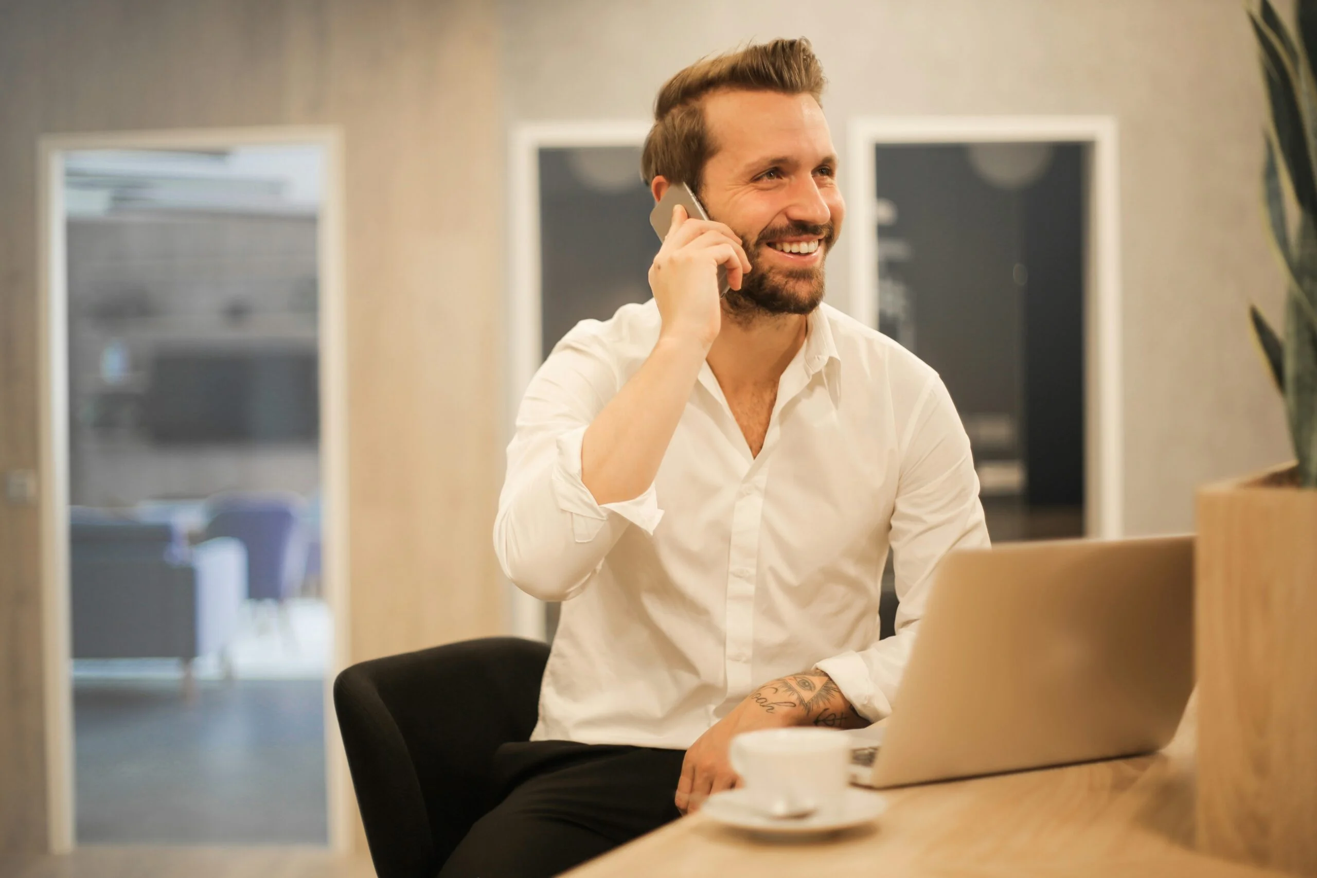 Smiling professional on a phone call, enjoying the benefits of an automated workflow.